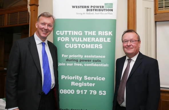 Image ©Licensed to i-Images Picture Agency. 08/12/2015. London, United Kingdom. Western Power Distribution Parliamentary Reception. Robert Symons (R) poses with Bill Wiggin MP in front of a Western Power Distribution banner about the priority assistance during power cuts. Picture by Daniel Leal-Olivas / i-Images